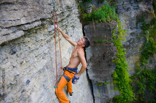 Climber climbs the rock.