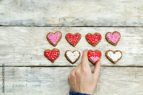 Male hands holding cookie in the forms of heart