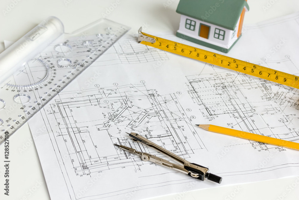 architect tools on white background with drawings apartments top view architect tools on white background with drawings apartments top view