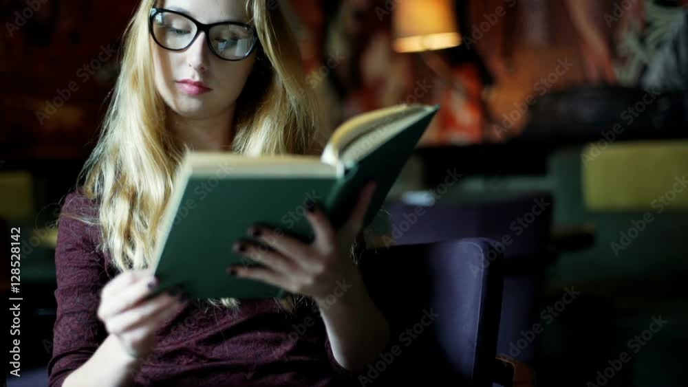 Girl in glasses sitting in the cafe and reading book, steadycam shot
Girl in glasses sitting in the cafe and reading book, steadycam shot