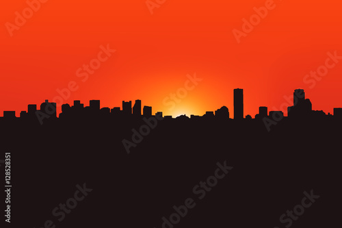 Silhouette of the city on the sunset background