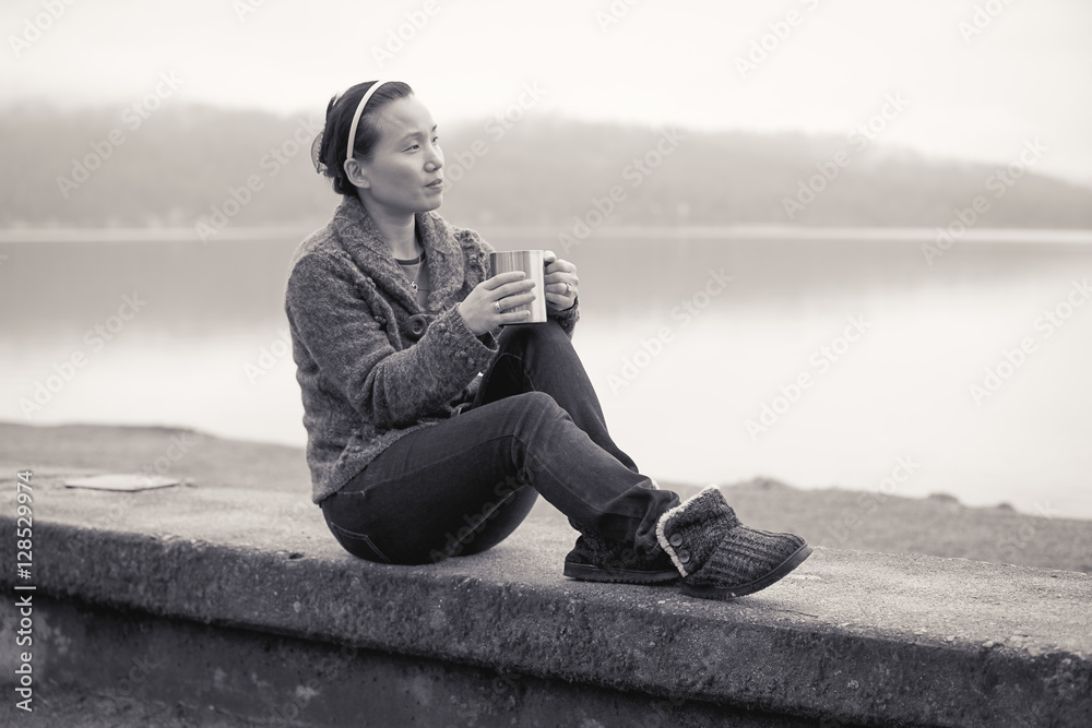 B&W of woman relaxing by lake. B&W of woman relaxing by lake.