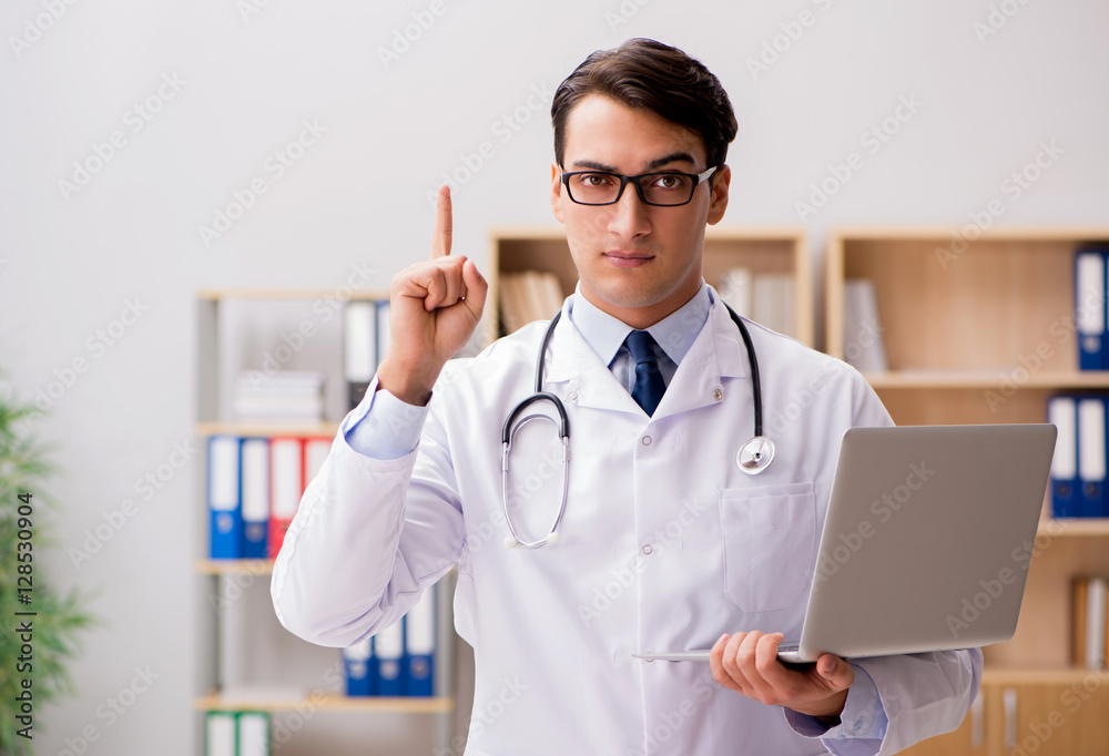 Young adult doctor with laptop computer Young adult doctor with laptop computer