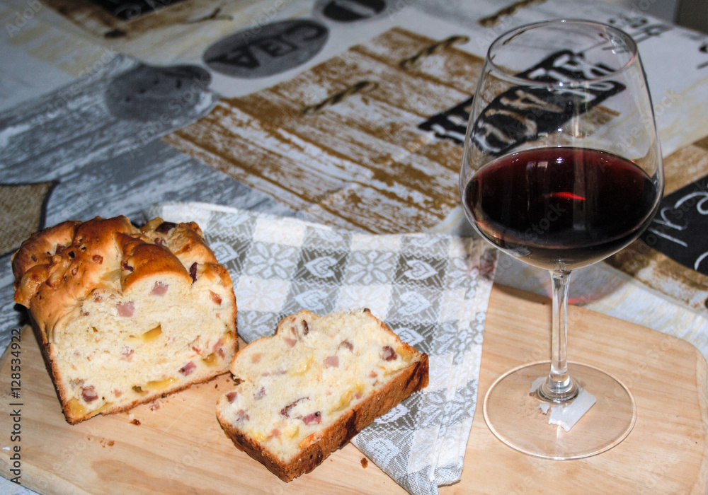 perfect italian brunch : salty plumcake with ham and cheese and  a glass of red wine 

