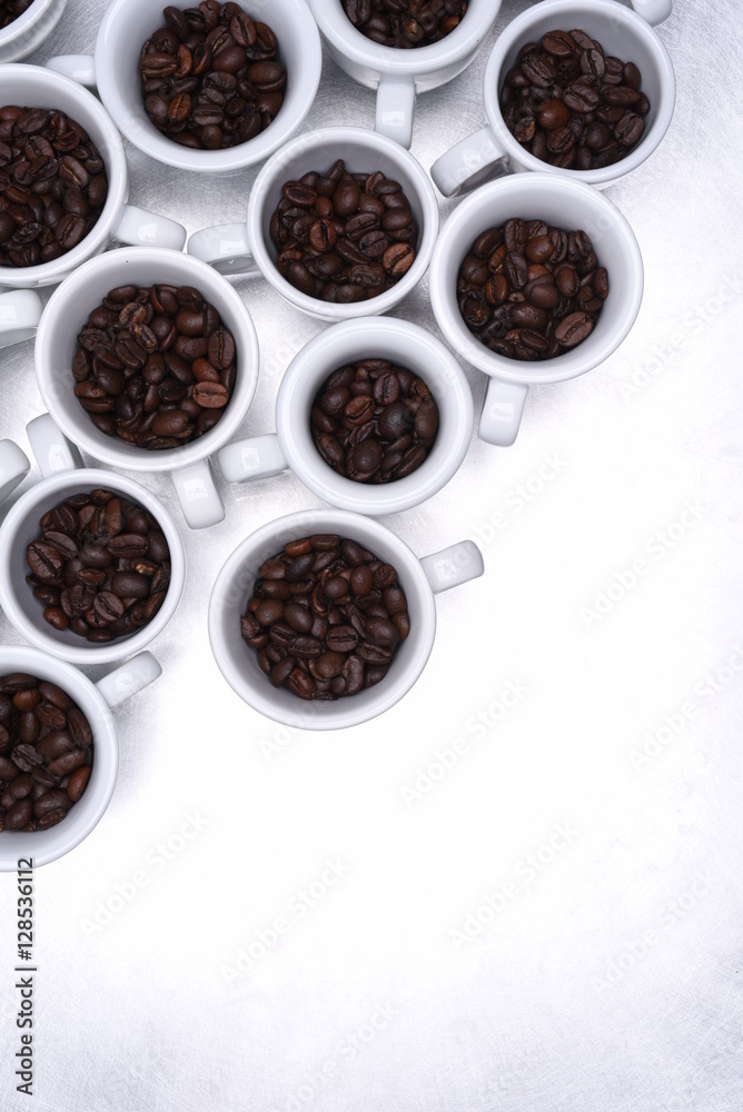 Group of coffee cup with roasted beans top view on metallic grey background Group of coffee cup with roasted beans top view on metallic grey background