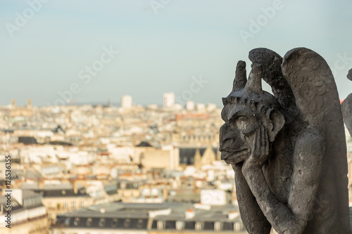 Mythical stone creature gargoyle on Notre Dame de Paris. View from the tower. Paris, France