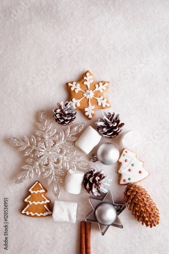 Beautiful Christmas tree made of gingerbread, marshmallows and Christmas decoration on light background