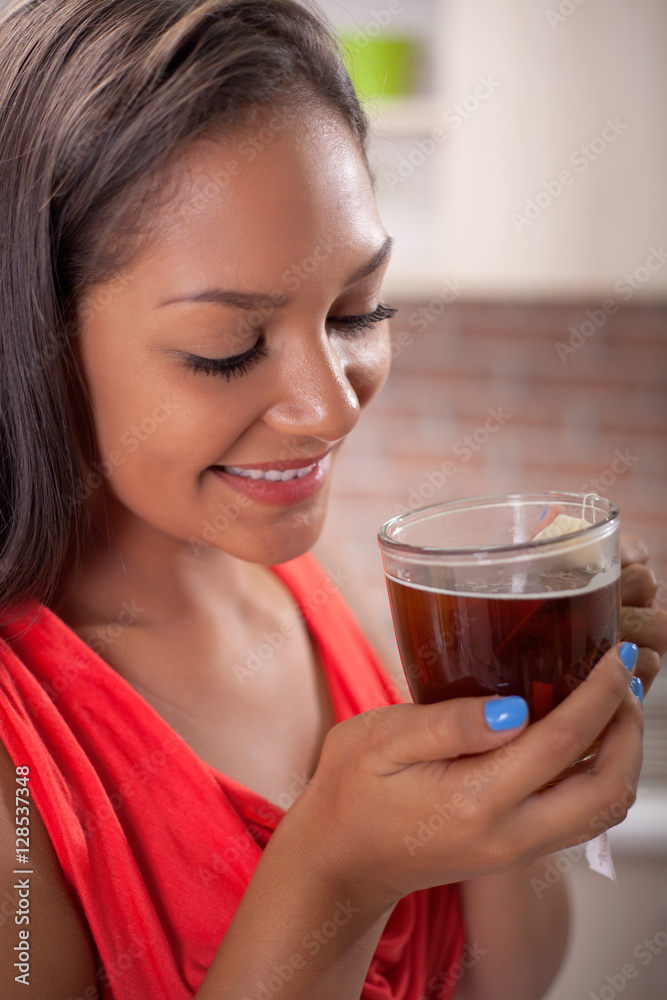 beautiful young Filipino drinking tea in the kitchen beautiful young Filipino drinking tea in the kitchen