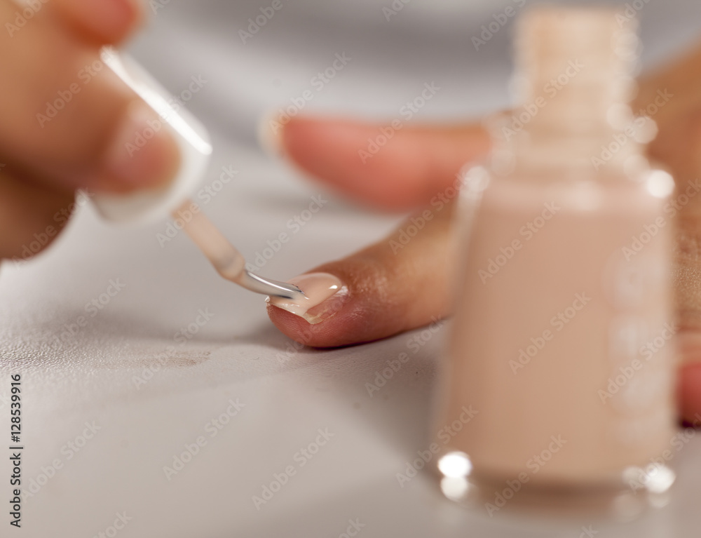 application of nail polish with a brush from the bottle application of nail polish with a brush from the bottle