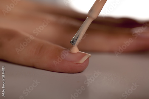 application of nail polish with a brush from the bottle