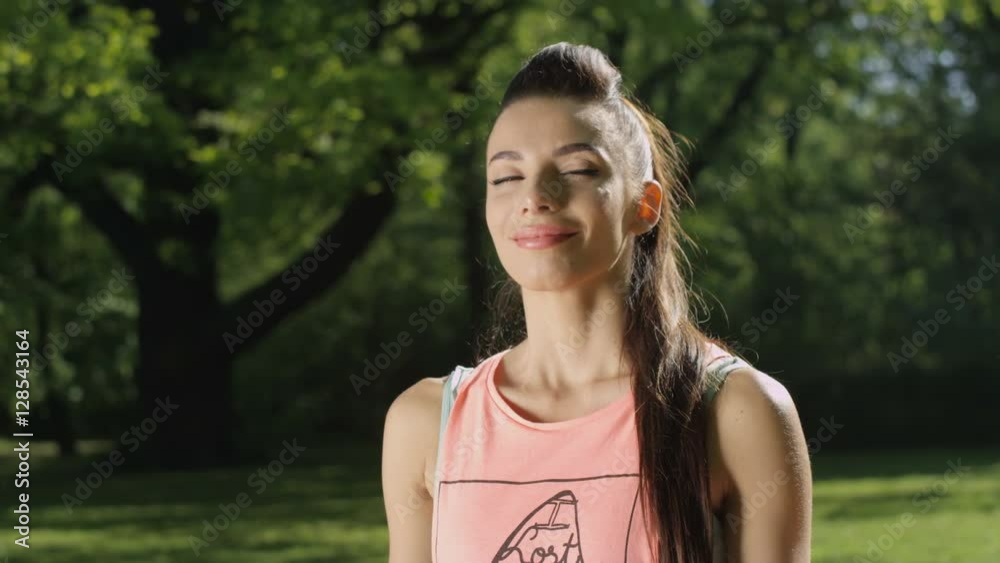 Young woman meditating in sunny park. Pretty girl training outdoors in landscape of nature. Sport and health. Shot on Red Epic. Young woman meditating in sunny park. Pretty girl training outdoors in landscape of nature. Sport and health. Shot on Red Epic.