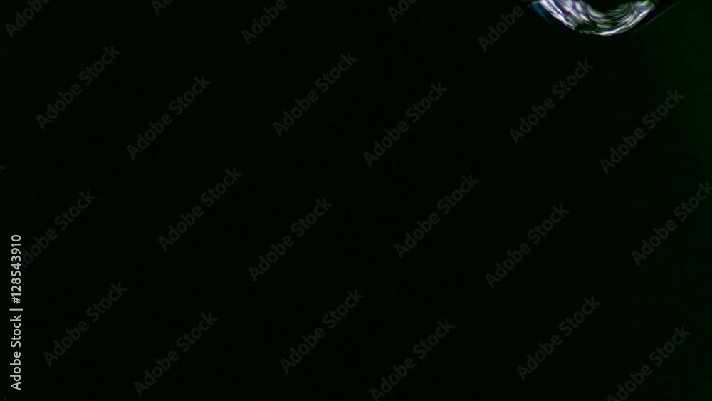 Single drop fall in a black background in slow motion