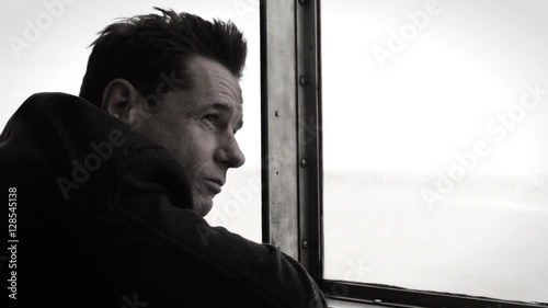 Man looking through window on staten island ferry