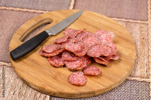 Flat lay overview sliced sausage on the wooden board