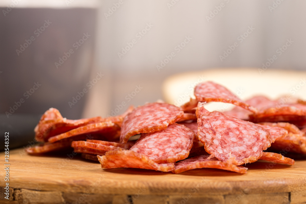 Sliced sausages on the wooden board with bread Sliced sausages on the wooden board with bread