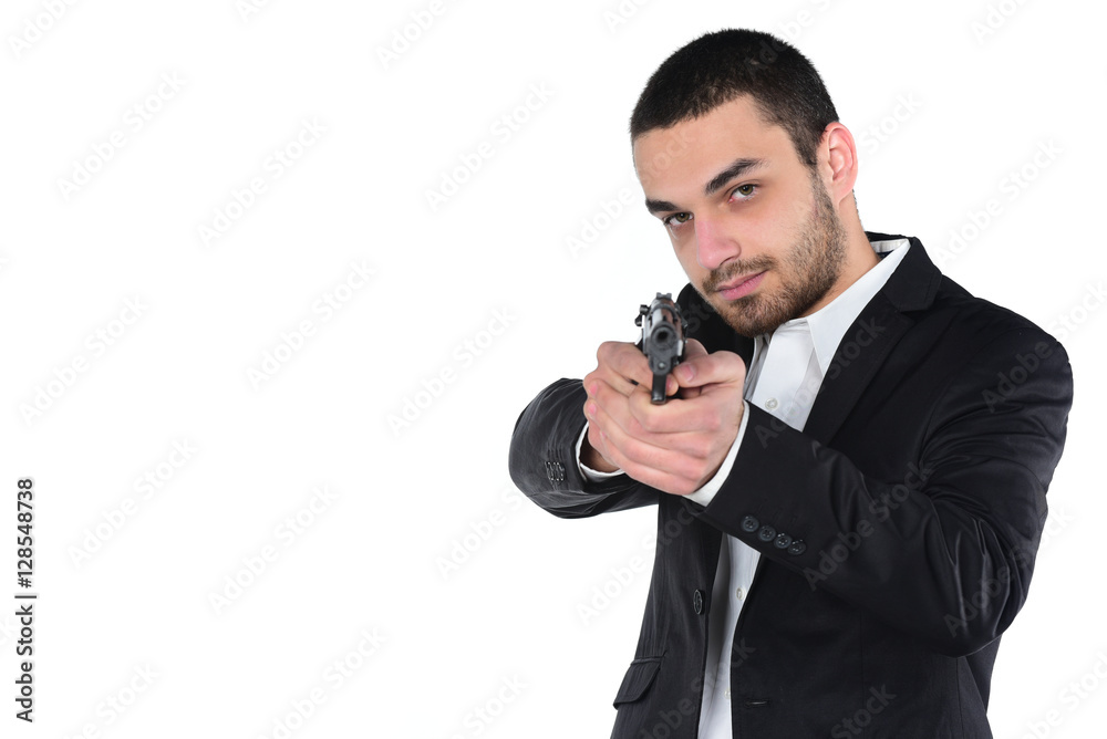 Attractive male holding gun in his hand. Assassin. Police officer. isolated on white Attractive male holding gun in his hand. Assassin. Police officer. isolated on white