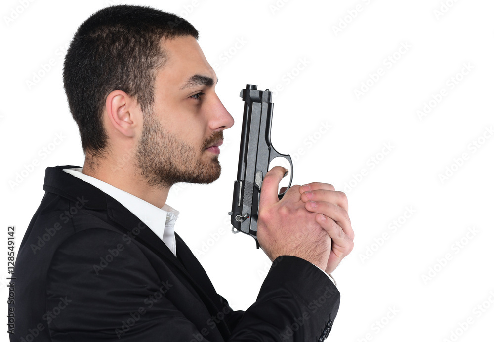 Attractive male holding gun in his hand. Assassin. Police officer. isolated on white Attractive male holding gun in his hand. Assassin. Police officer. isolated on white