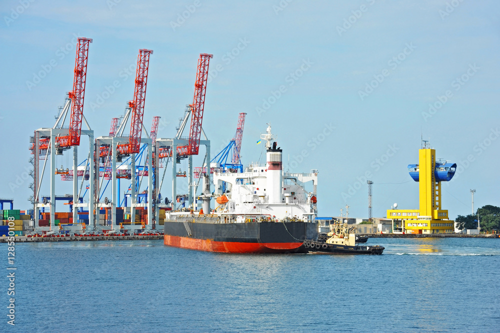 Tugboat assisting bulk cargo ship