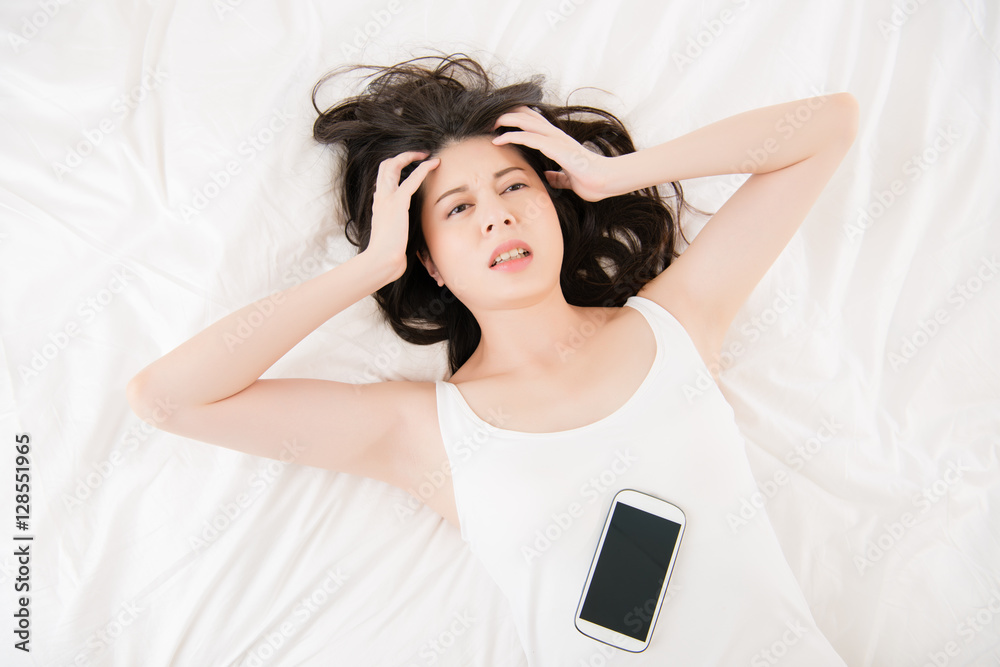 Fototapeta premium asian woman feel headache use smart phone cry for help