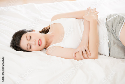 Beautiful asian woman suffering from stomach menstruation period