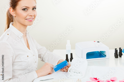 Female beautician making nails.