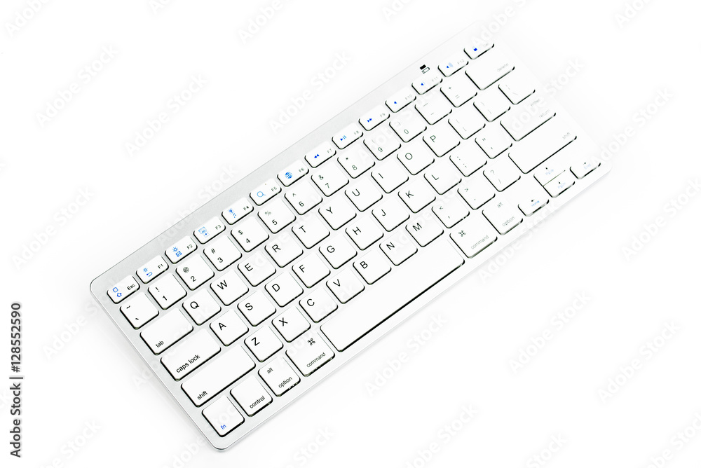 Modern aluminum computer keyboard. Wireless, blue-tooth computer keyboard isolated on white background. Close up of whit, silver wireless aluminum fingerboard with english letters.Top, side view. Modern aluminum computer keyboard. Wireless, blue-tooth computer keyboard isolated on white background. Close up of whit, silver wireless aluminum fingerboard with english letters.Top, side view.