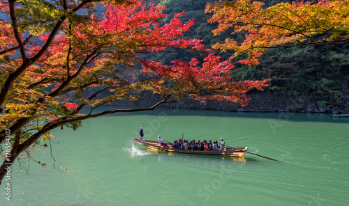 Arashiyama and tourist boat in autumn season