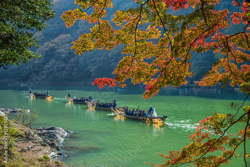 Arashiyama and tourist boat in autumn season photo