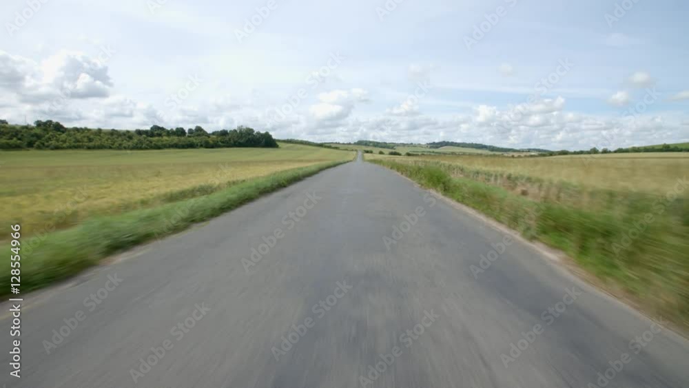 Exterior view from front of car travelling down country road Exterior view from front of car travelling down country road