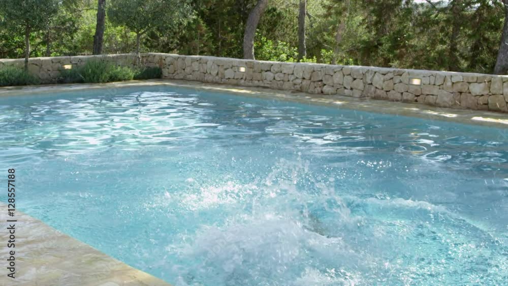 Children On Vacation Jumping Into Outdoor Pool Children On Vacation Jumping Into Outdoor Pool