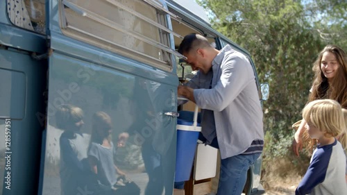 Wallpaper Mural Family packing up their camper van for a road trip vacation Torontodigital.ca