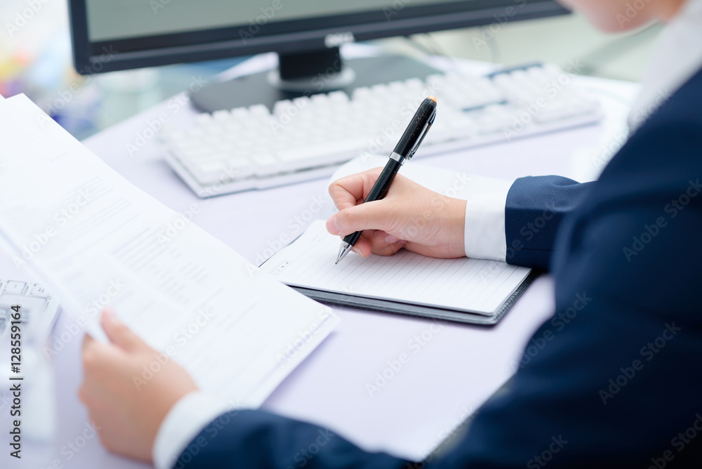 Businesswoman working at desk in office. Businesswoman working at desk in office.