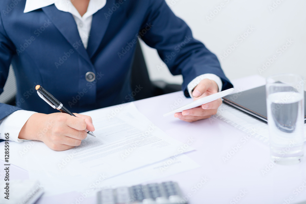 Businesswoman using smart phone work at desk. Businesswoman using smart phone work at desk.