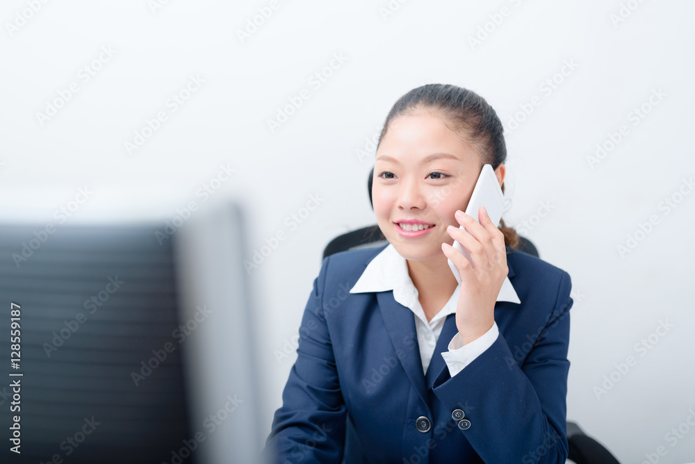 Young business woman using smart phone working at her workplace. Young business woman using smart phone working at her workplace.