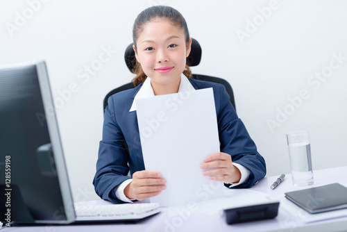 Young business woman collating documents at desk. photo