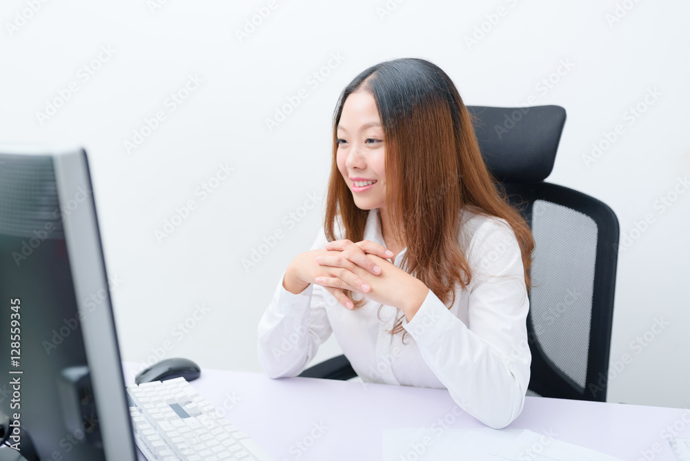 Young businesswoman working on computer. Young businesswoman working on computer.