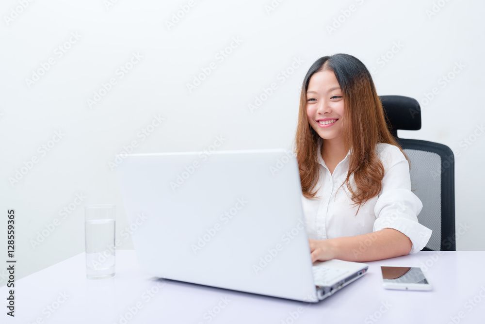 Young business woman working on laptop. Young business woman working on laptop.