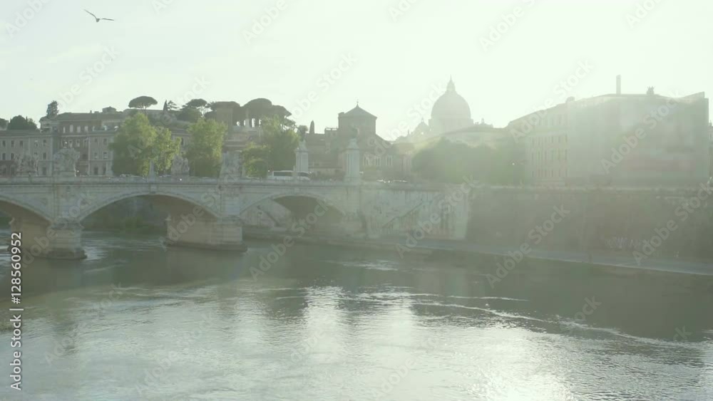Sunlit Rome, beautiful morning view of old city with bridge across wide river