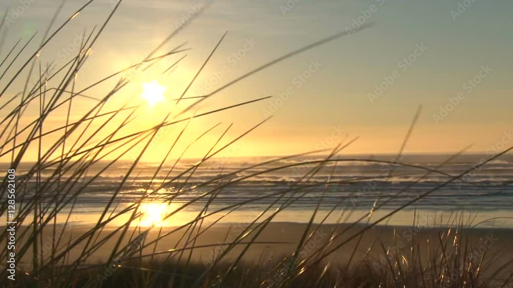 Coastline at sunset, real time at pacific ocean on windy evening by sand dunes.