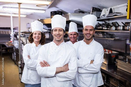 Group of happy chefs smiling at the camera photo