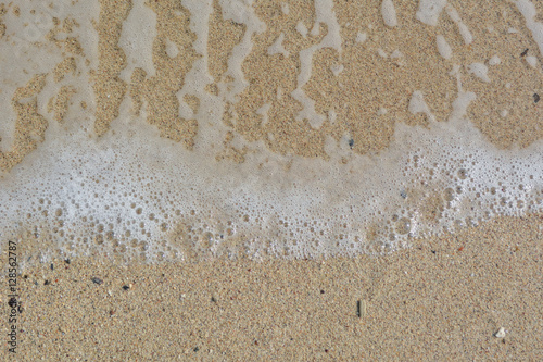 Foamy white waves on the beach