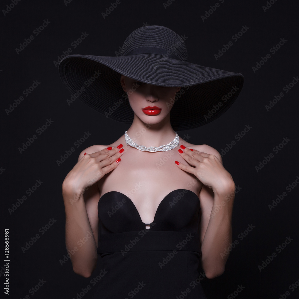A necklace of diamonds on the neck of a luxurious woman in a hat. A necklace of diamonds on the neck of a luxurious woman in a hat.