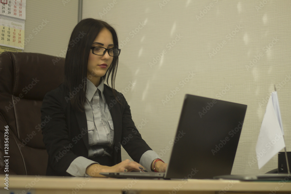 assistant in office working with laptop.This photo has a blank space for your text. assistant in office working with laptop.This photo has a blank space for your text.