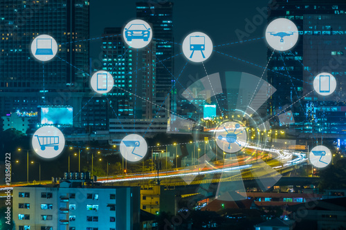 Internet of Things and Smart city concept. Smart things icons mesh on city traffic night background.