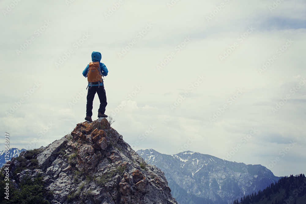 successful woman backpacker enjoy the view on mountain peak successful woman backpacker enjoy the view on mountain peak