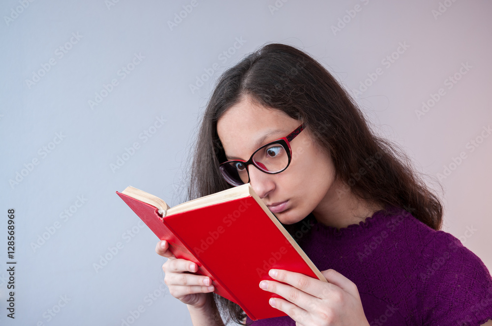 Beautiful girl reading a book with interest Beautiful girl reading a book with interest