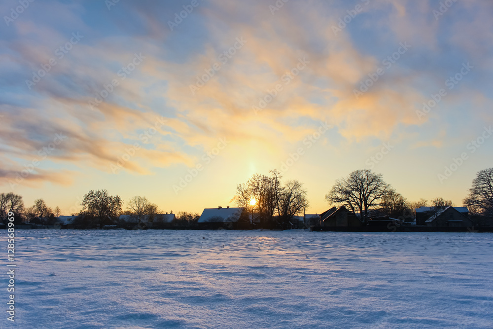 The rays of the sun in winter snowy field, beautiful landscape