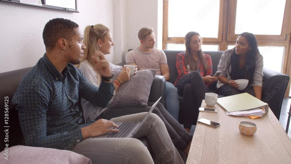 Students Relaxing In Lounge Of Shared Accommodation Students Relaxing In Lounge Of Shared Accommodation
