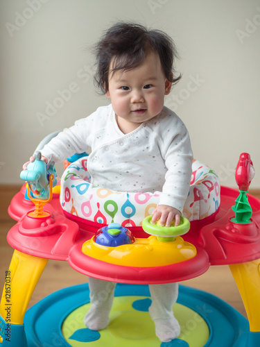 Asian baby girl playing entertainer toy