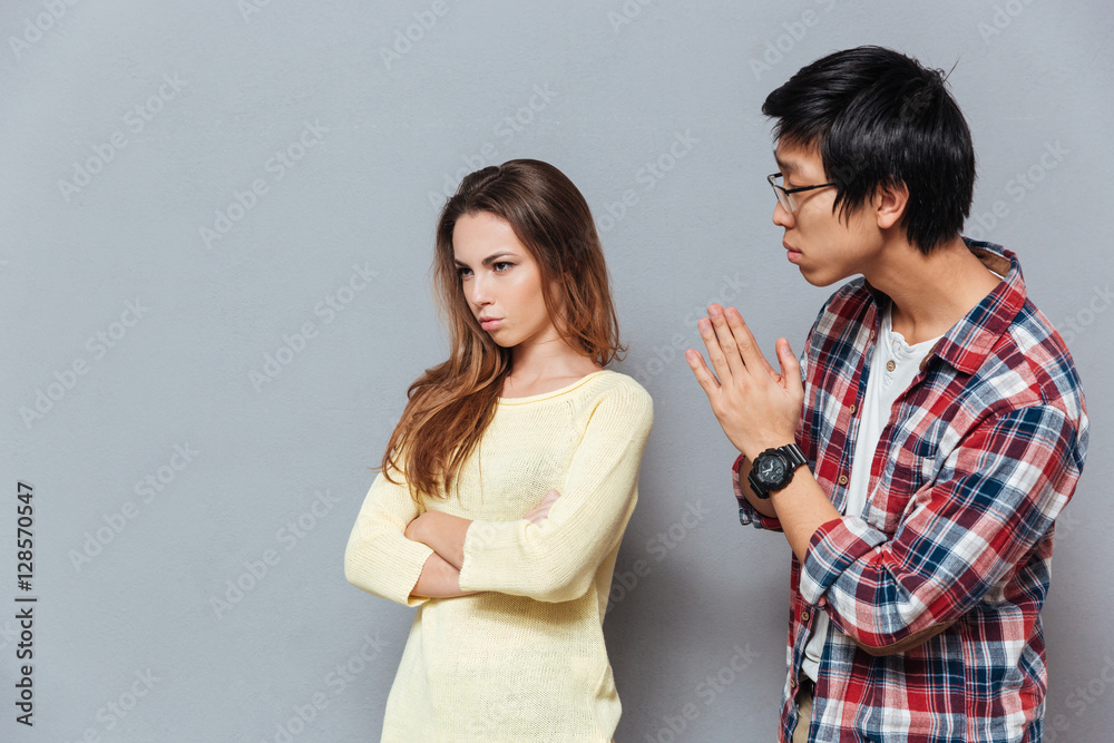 Young asian man asking for forgiveness his girlfriend Young asian man asking for forgiveness his girlfriend